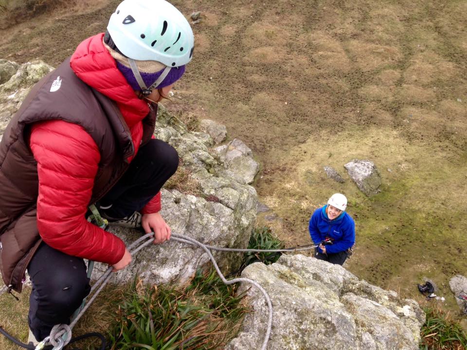 Sara problem solving on a group abseil during her SPA assessment in Pembrokeshire