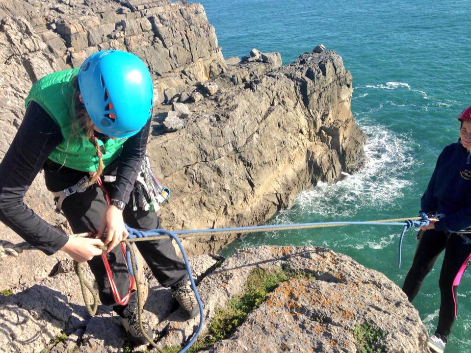 Ella using a releasable abseil during her SPA training in Pembrokeshire