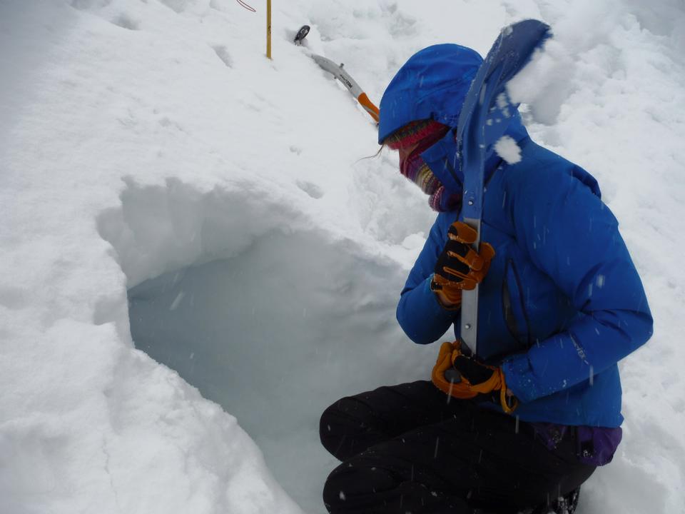 Digging an emergency shelter in the snow