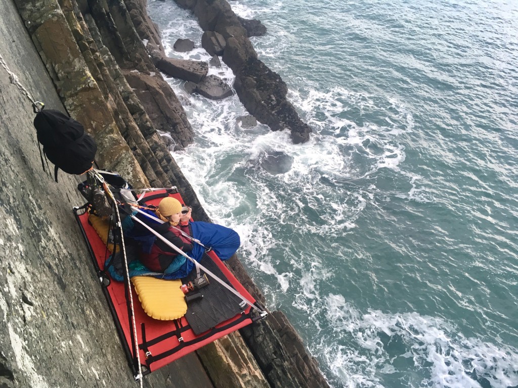 Relaxing on the Portaledge with a coffee, Cliff Camping in Pembrokeshire..