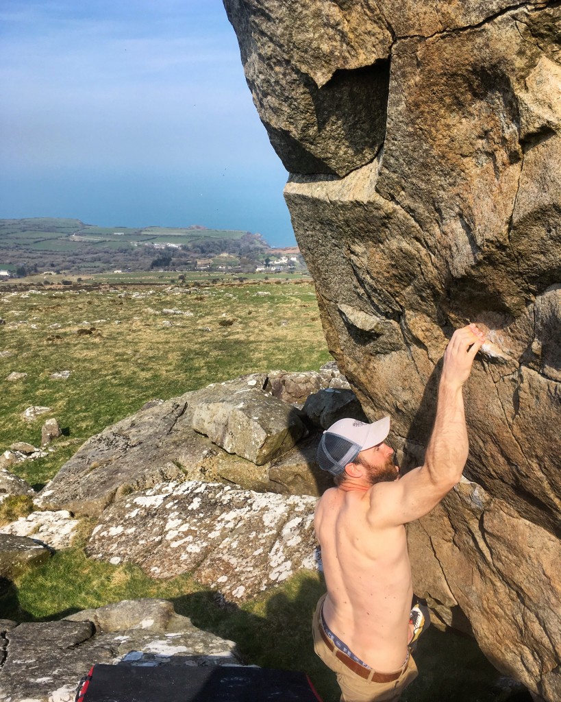 Bouldering at Dinas, Pembrokeshire. Alun on the 3 star Gargoyle, V4 