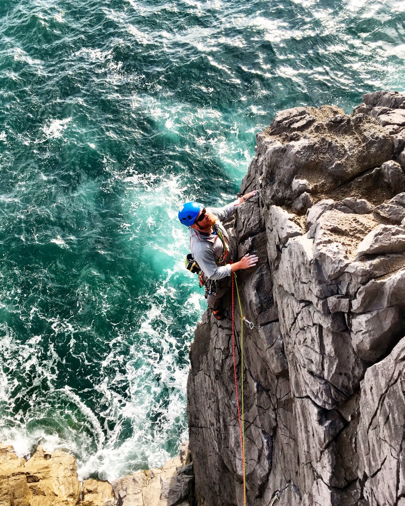 Charlie leading on the sea cliffs on a private climbing day in Pembrokeshire..