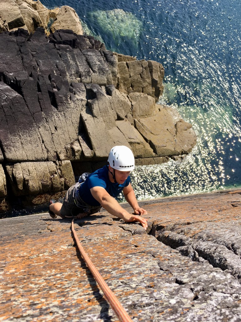 Rich experiencing seacliff climbing for the first time at Porth Clais.